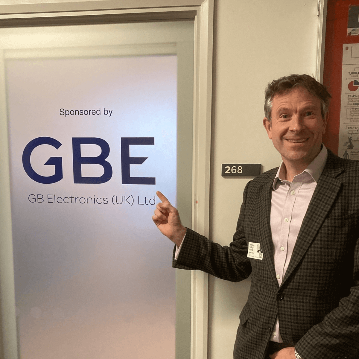 GBE Director posing in front of a room at Worthing College that is proudly sponsored by GBE.